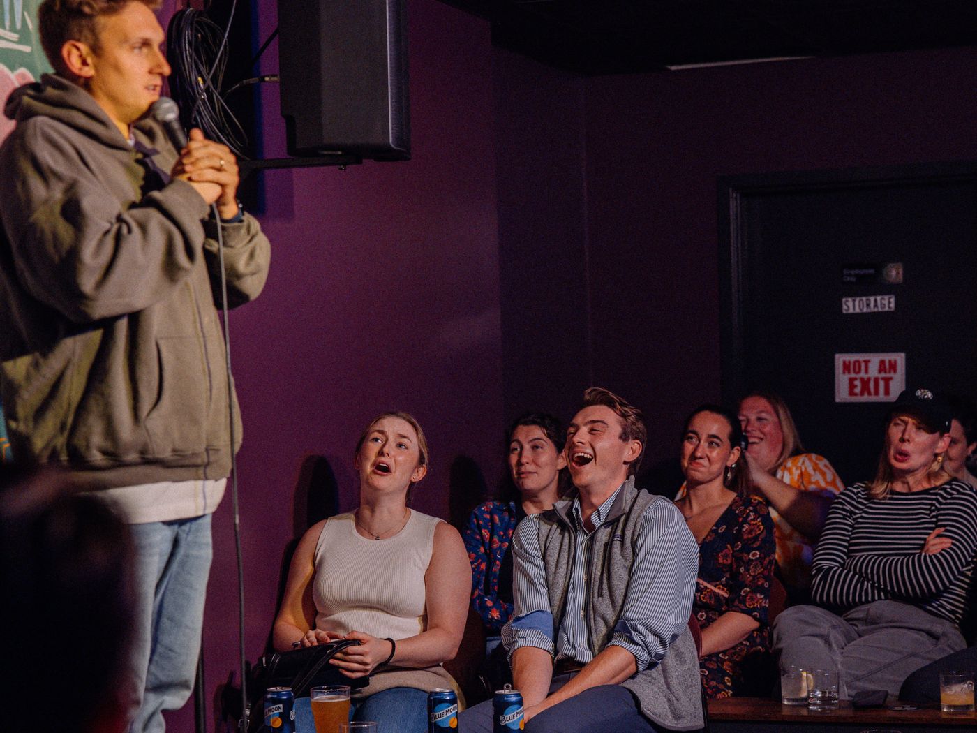 A comedian at the mic as the front row laughs at Goofs Comedy Club